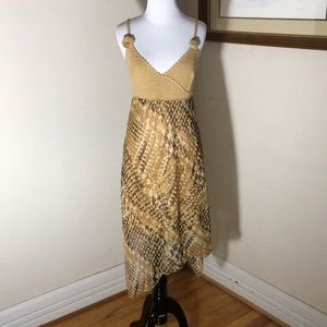 Address asymmetrical dress with crocheted top.